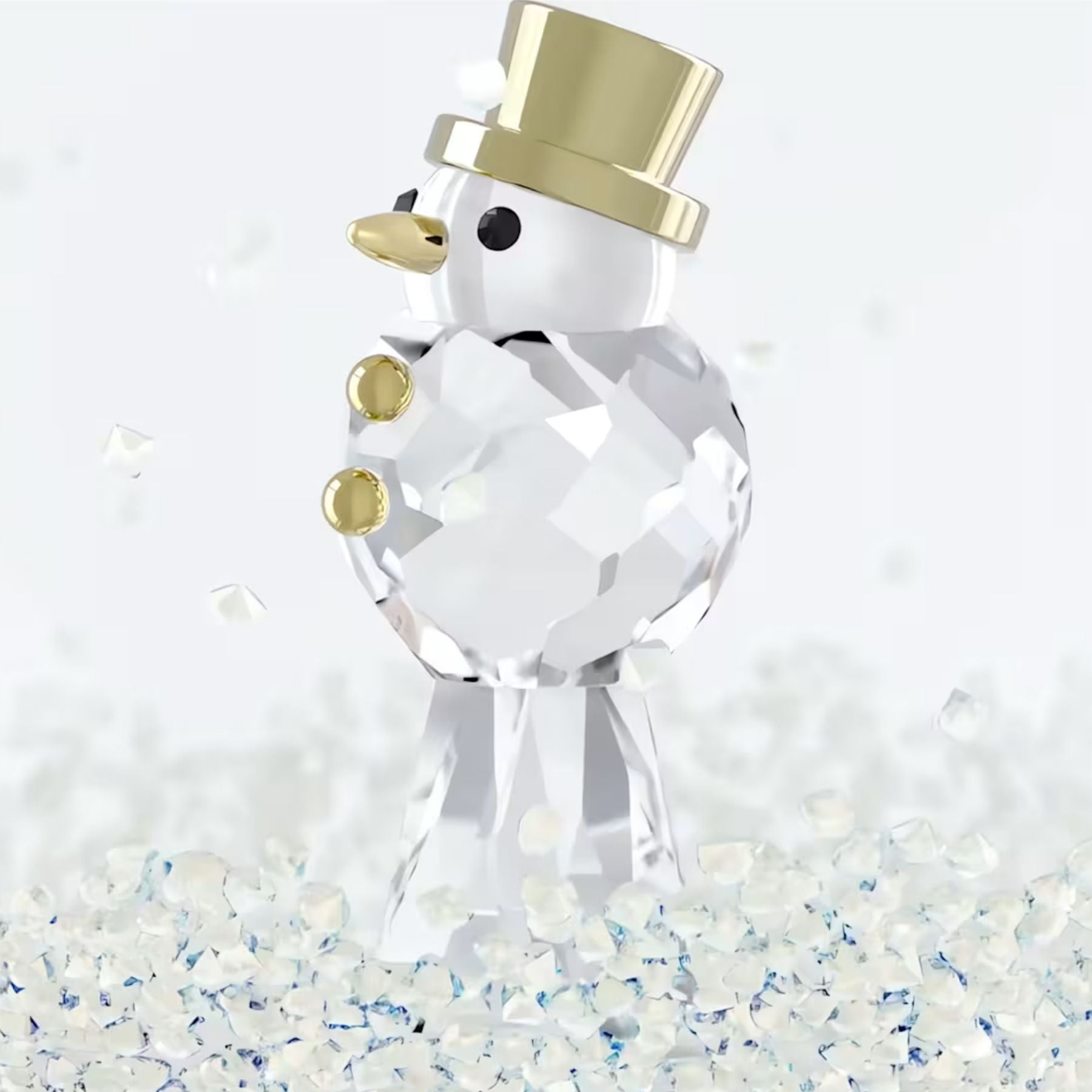 Swarovski kristallinen lumiukko kullanvärisellä silinterihatulla, nenällä ja napeilla kimaltavien koristekiteiden keskellä