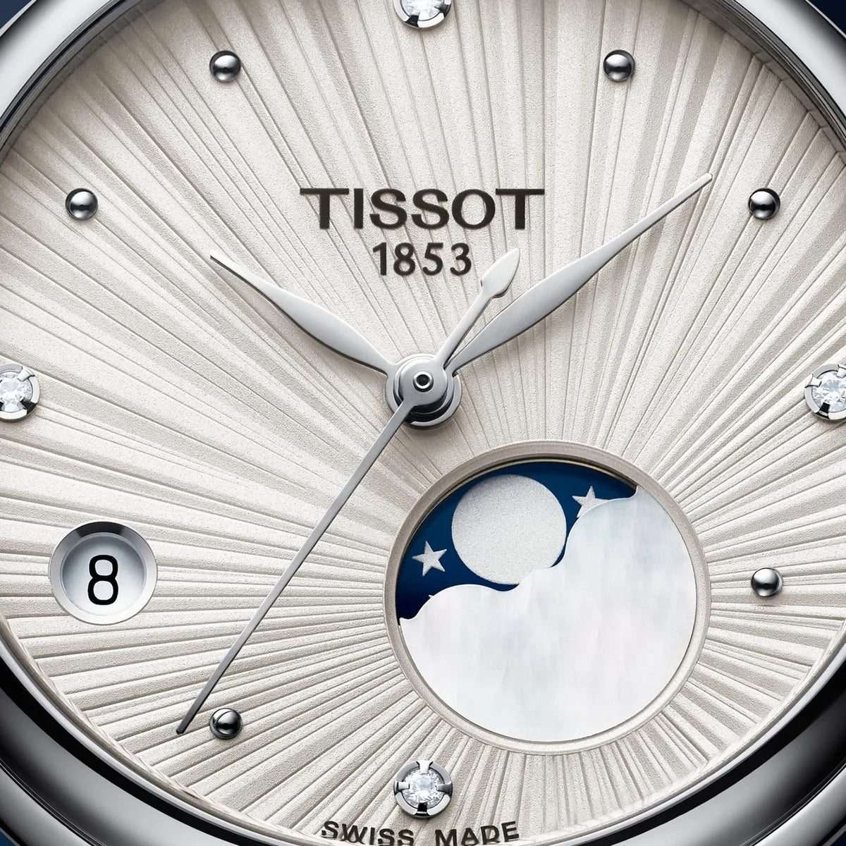 Tissot rannekellon vaalea hopeanvärinen kellotaulu kuunvaihenäytöllä, päivämääränäytöllä ja neljällä timantilla